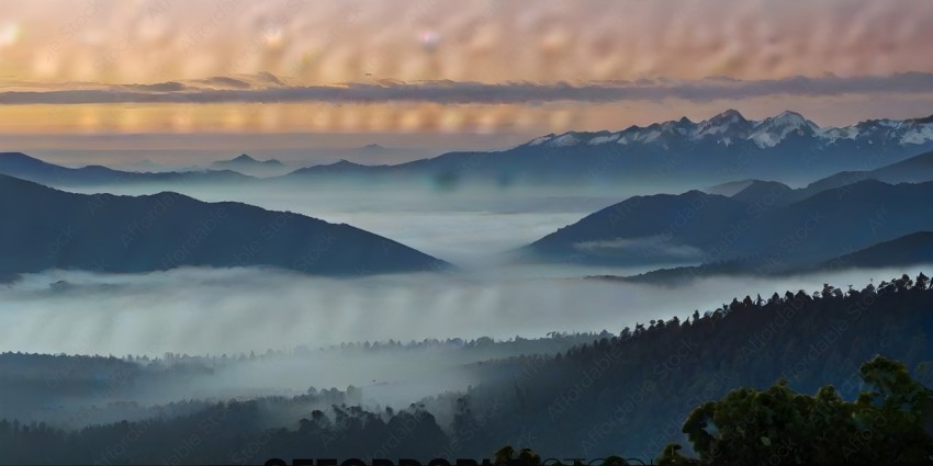 A mountain range with fog and clouds