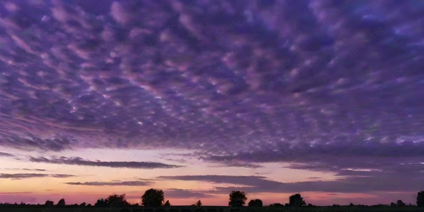 A beautiful sunset with a purple sky and clouds