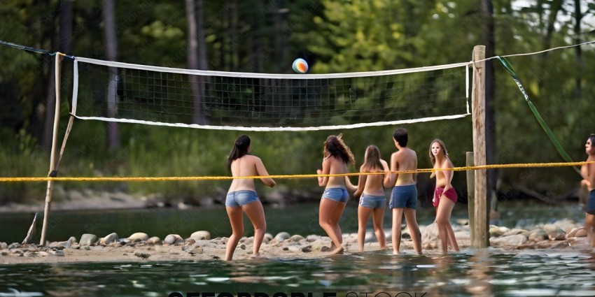 A group of people playing volleyball in the water
