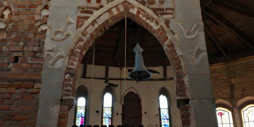 A bell hangs from the ceiling of a church
