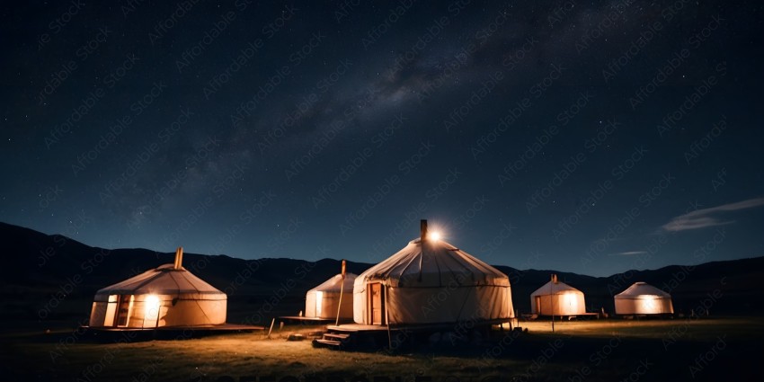 A group of white tents with a starry sky in the background