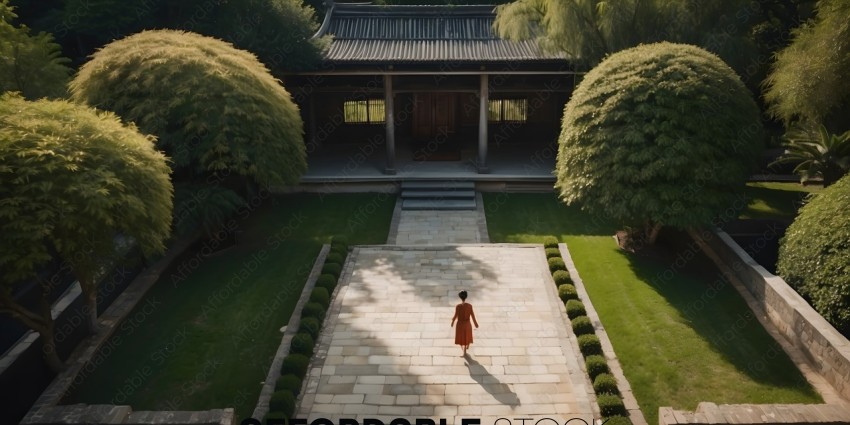 A woman walking down a path in a garden