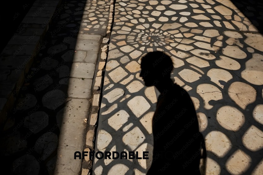 A person walking in the shade of a patterned floor