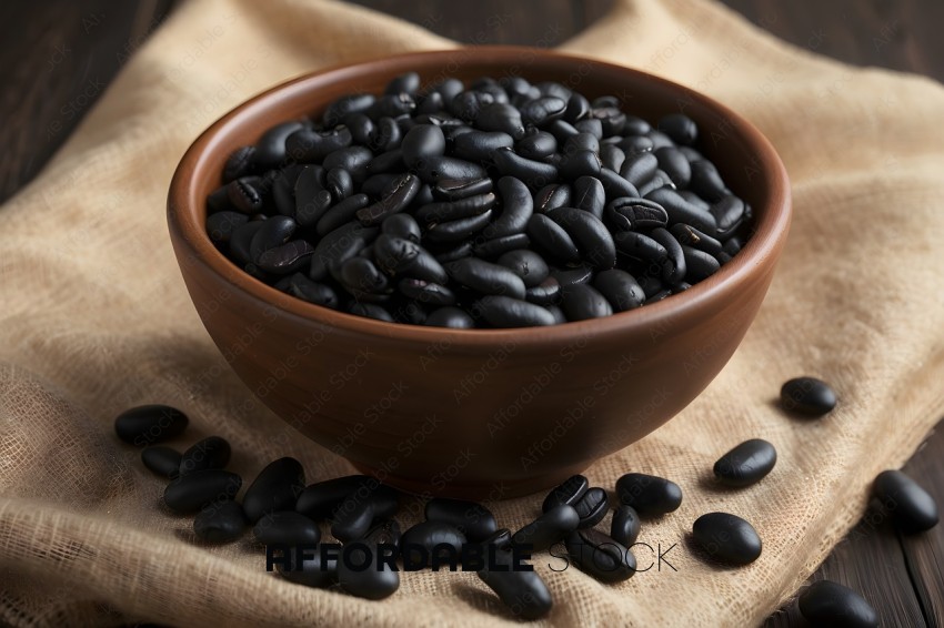 A bowl of black beans on a brown cloth