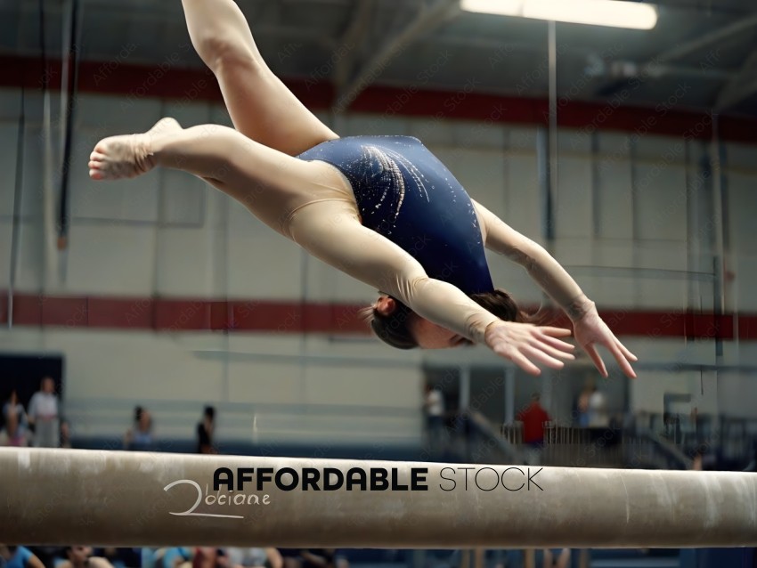 Gymnast in blue leotard doing a handstand on a balance beam