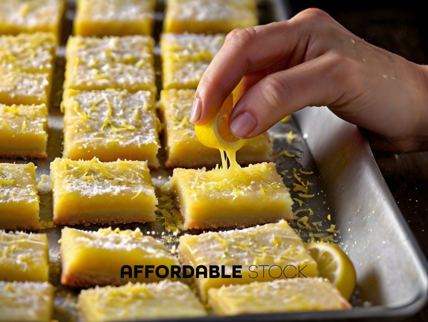 A person is spreading lemon zest on a dessert