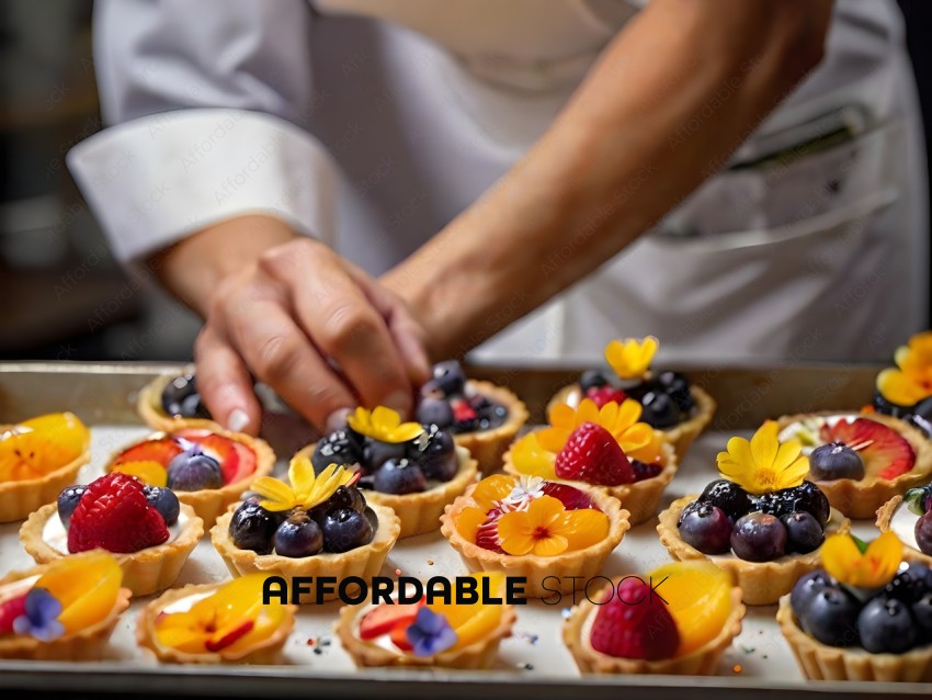 A chef prepares a variety of fruit tarts