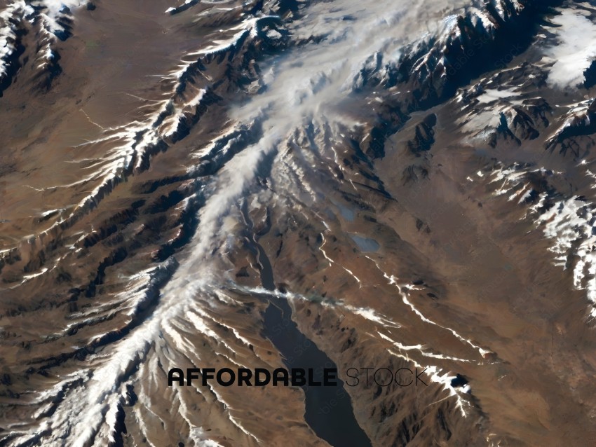 A mountain range with snow and smoke