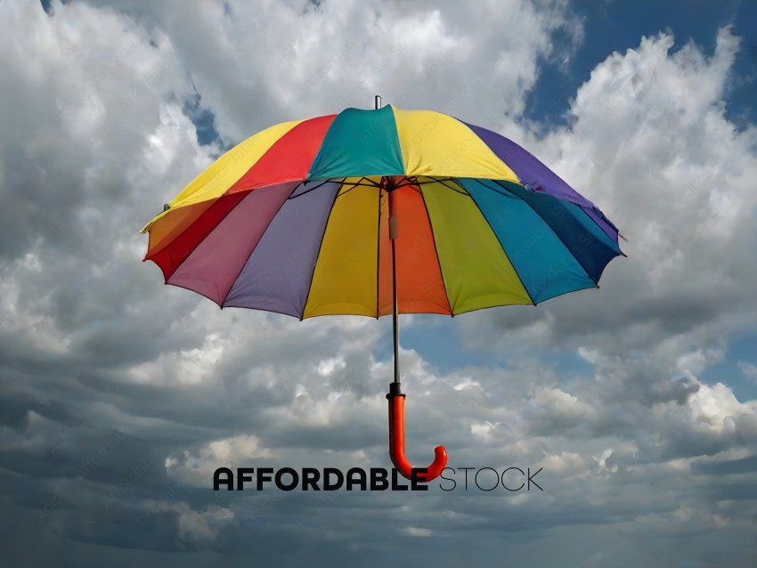 A rainbow umbrella with a red handle