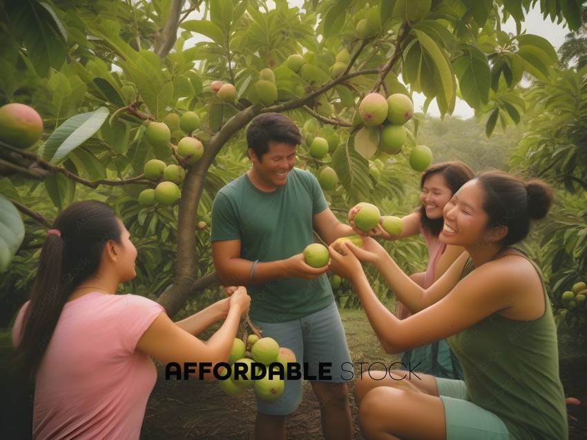 Four women and one man are laughing and holding fruit