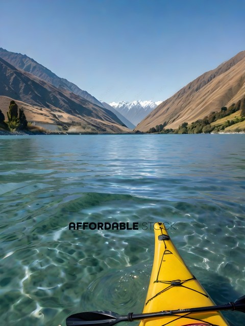 A yellow kayak in a lake with mountains in the background