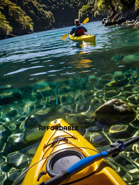 A yellow kayak with a blue paddle in the water