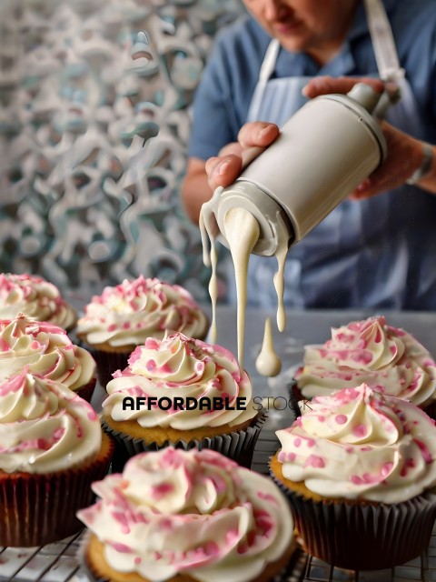 A person pouring frosting into cupcakes