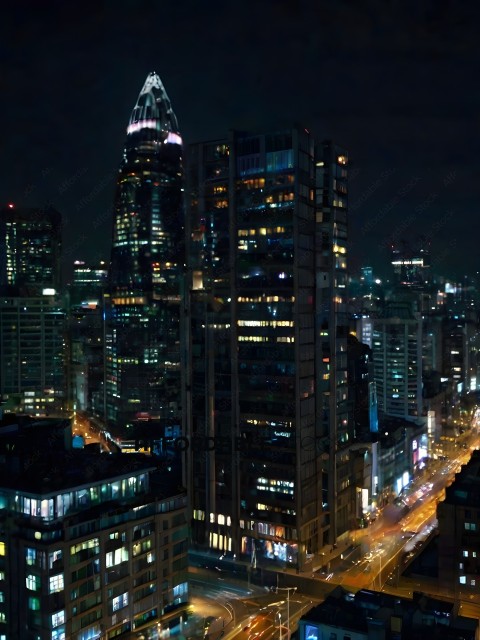 A view of a city at night with a large building in the foreground
