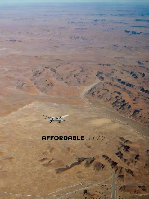 A plane flying over a desert landscape