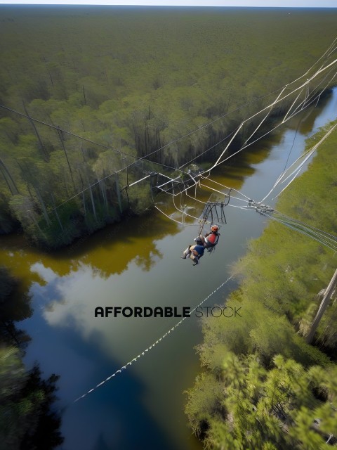Two people are suspended in the air on a zip line