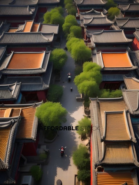 People riding bikes down a path between buildings