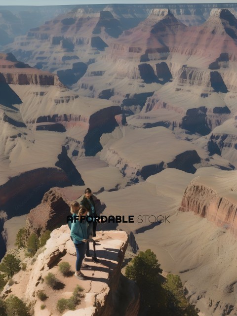 Three people standing on a cliff overlooking a canyon