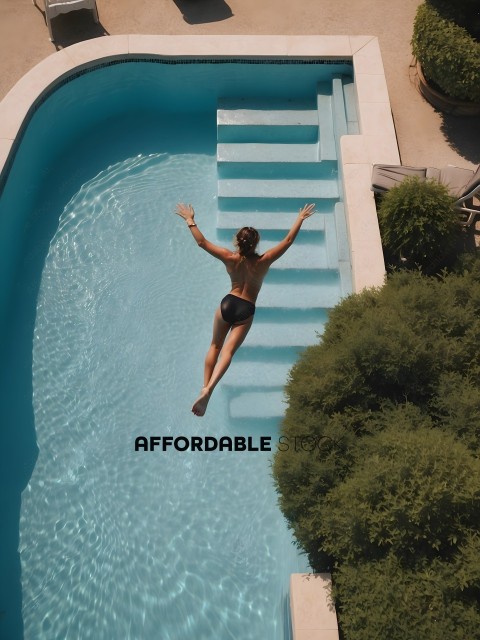 A woman diving into a pool with stairs