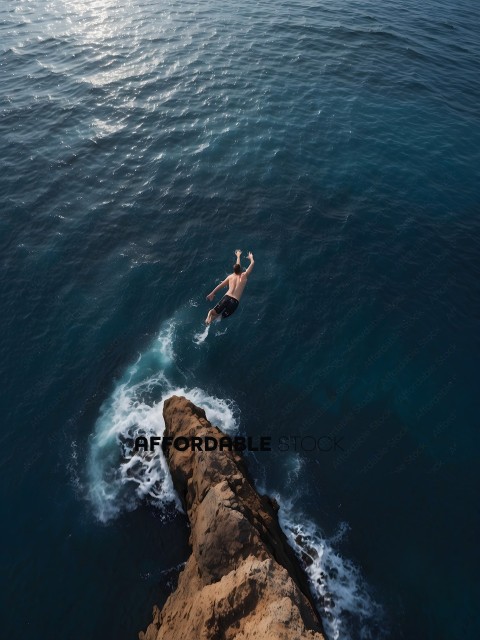 Man diving off a rock into the ocean