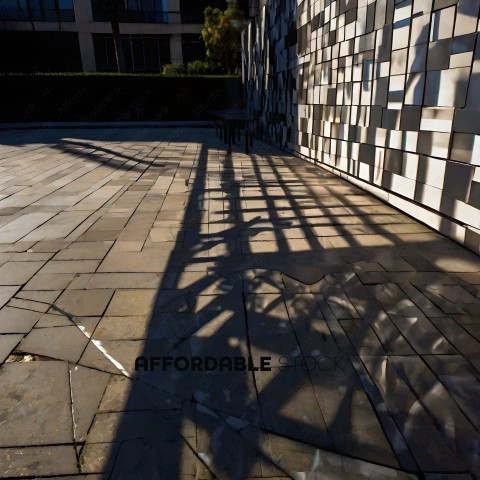 A shadow of a bench on a brick walkway