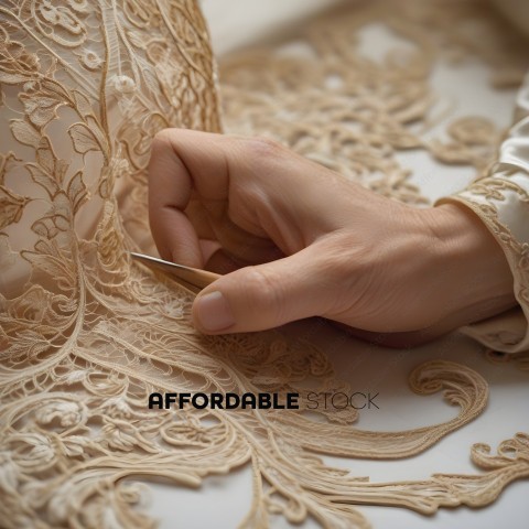 A person is cutting a piece of lace with a pair of scissors