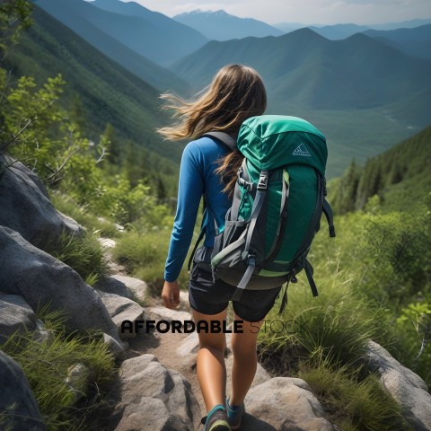 A woman wearing a green backpack is walking on a rocky trail