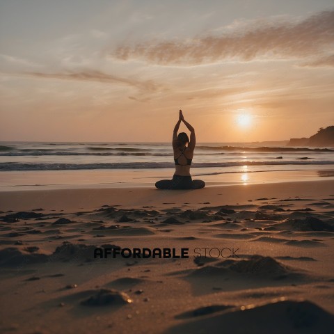 A woman in a yoga pose on the beach at sunset