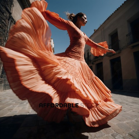 A woman in a long orange dress dances in the street