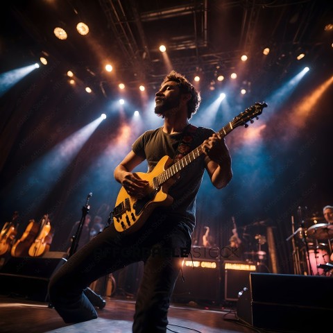 A man playing guitar on stage